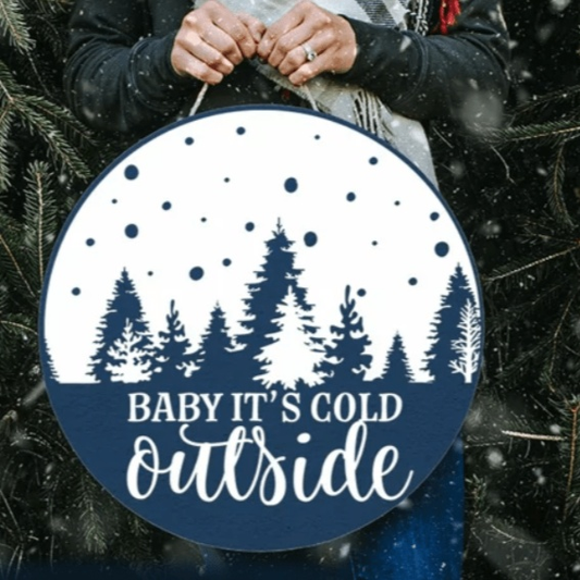 Handmade "Baby It's Cold Outside" wood sign with festive tree design.