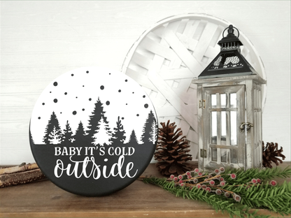 Handmade "Baby It's Cold Outside" wood sign with pine tree design, perfect for holiday decor.