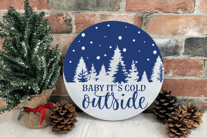 Handmade "Baby It's Cold Outside" wood sign with winter tree design, blue and white color, rustic holiday decor.