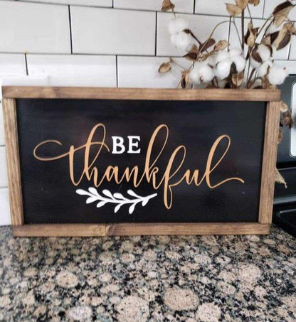 Handcrafted "Be Thankful" wood sign with rustic distressed finish, chalk black background, white and orange lettering, and stained pine frame.