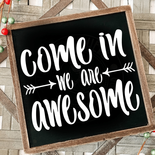 Come in We Are Awesome wood sign with rustic frame and white lettering on black background.