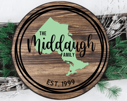 Custom round family wood door sign with personalized text and map design.