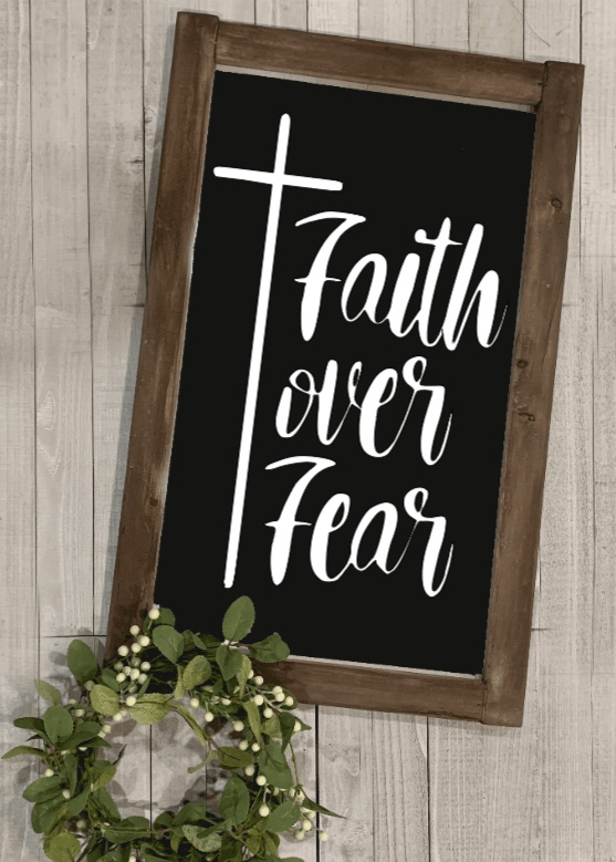 Faith over Fear rustic wood sign with stained frame and black background.