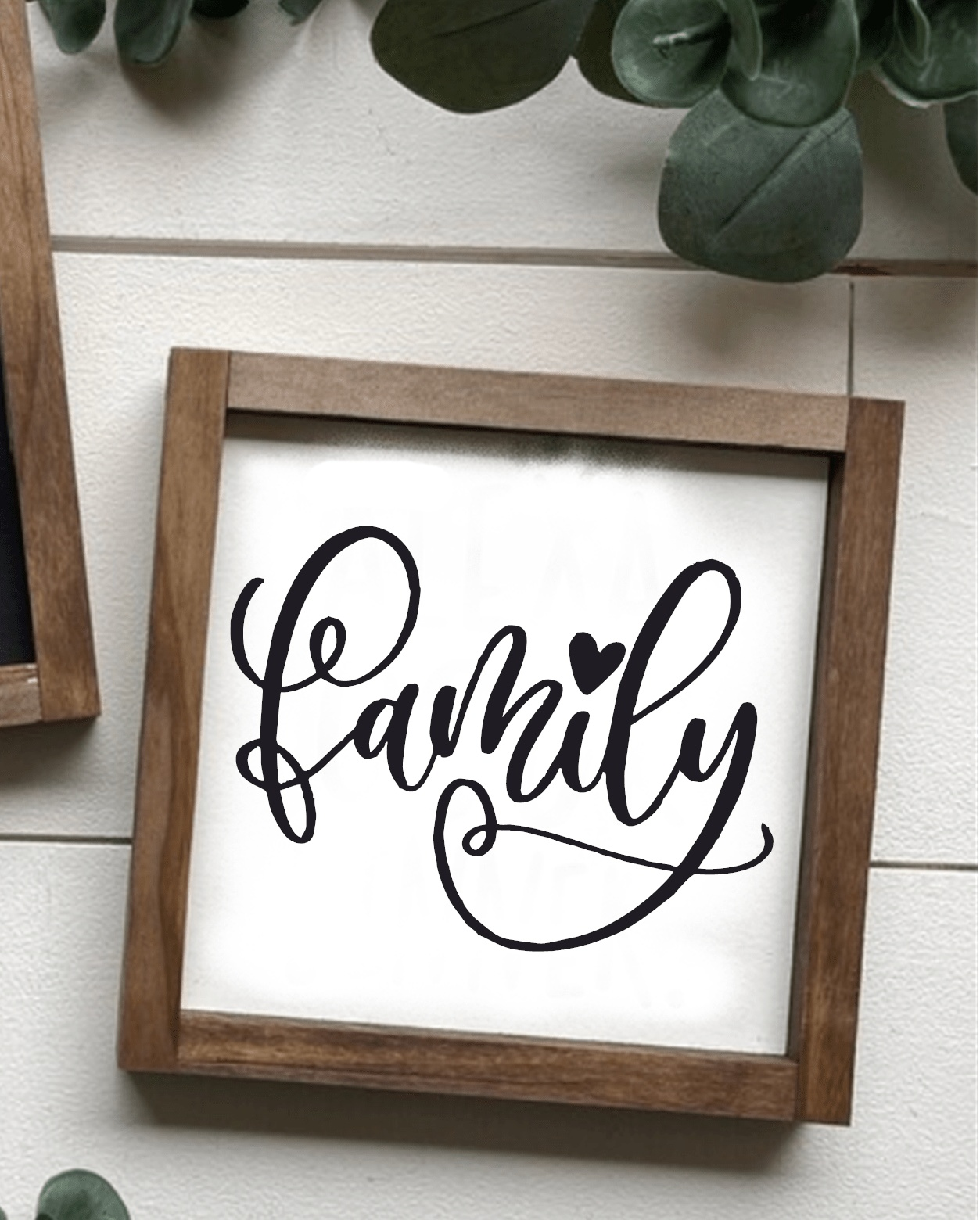 Handcrafted family wood sign with black script on white background, framed in stained wood.