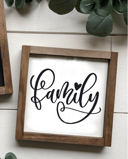 Handcrafted family wood sign with black script on white background, framed in stained wood.