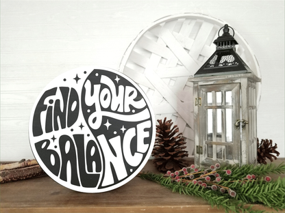 Round wooden sign with "Find Your Balance" in black and white yin-yang design, ideal for home décor and gifts.