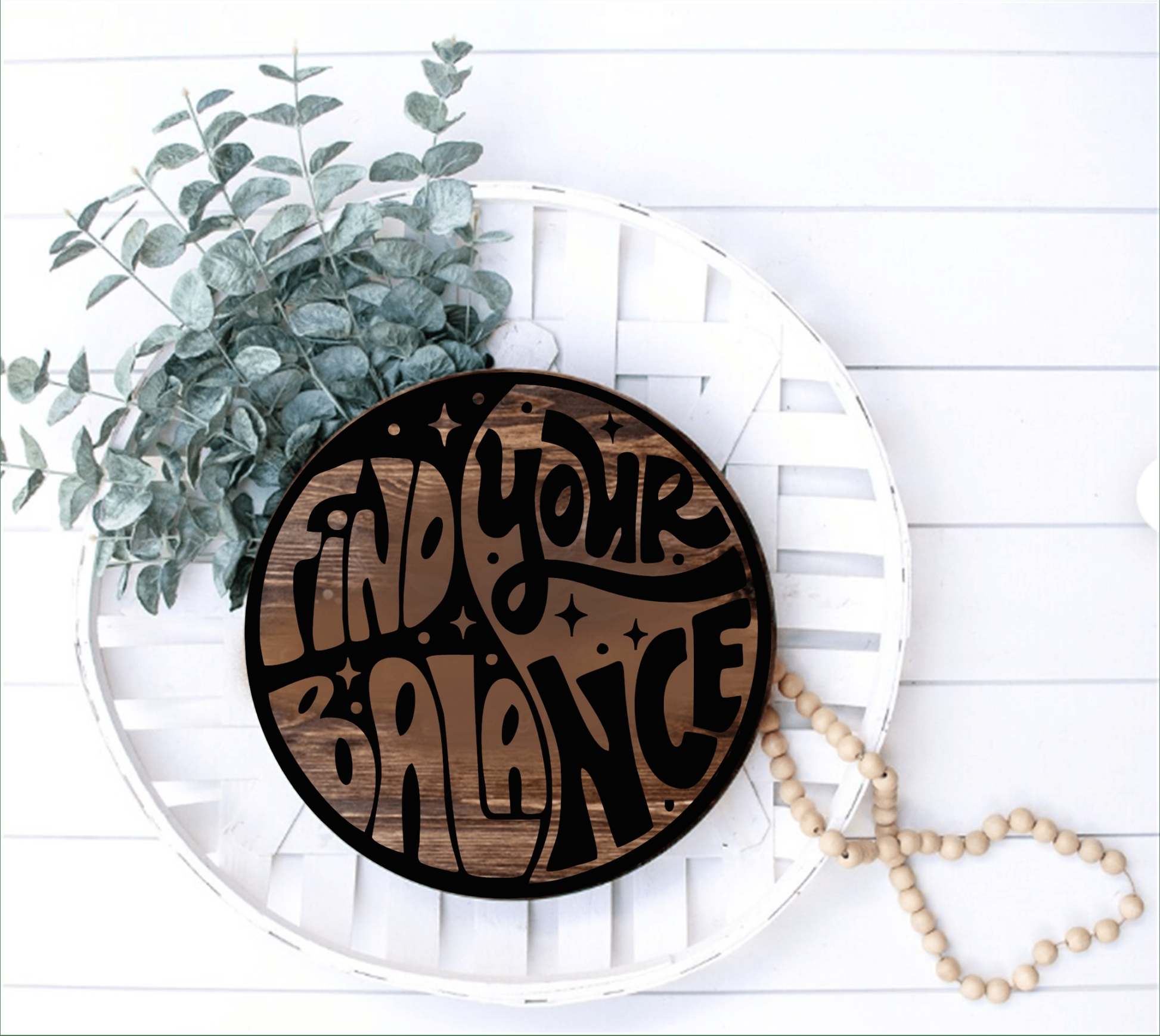 Round wooden "Find Your Balance" inspirational sign with yin-yang design.
