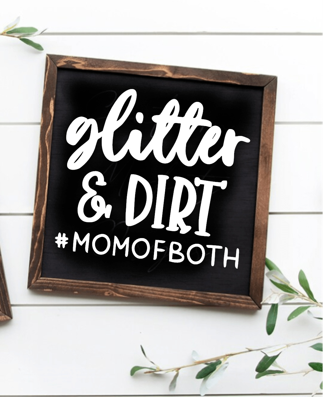 Handcrafted framed wood sign with "Glitter and Dirt #MomofBoth" text in white on black background.