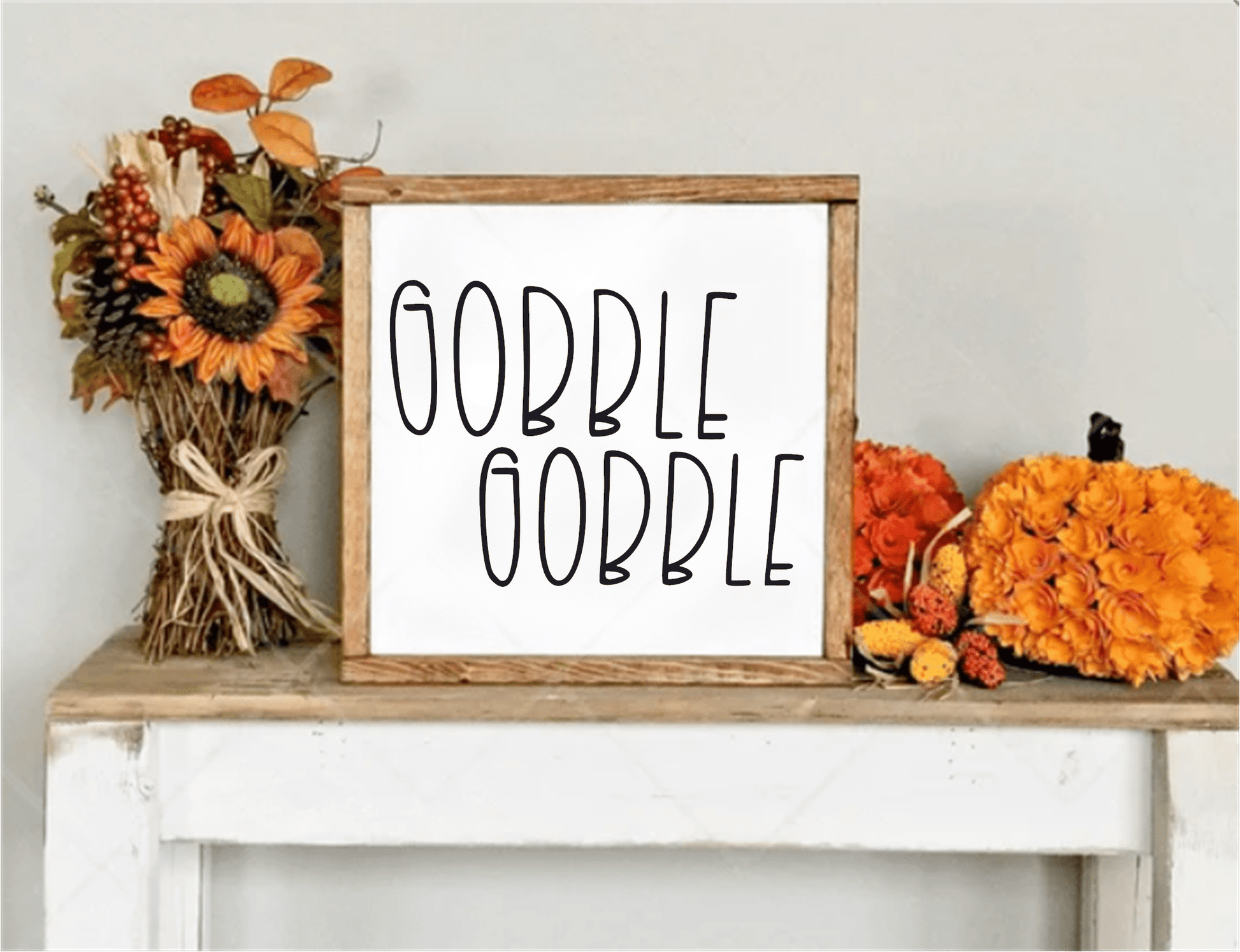 Handcrafted "Gobble Gobble" framed wood sign with autumn decor.