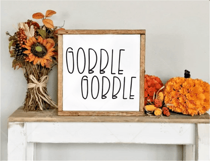 Handcrafted "Gobble Gobble" framed wood sign with autumn decor.