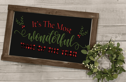 Handmade wood holiday sign with "It's the Most Wonderful Time of the Year" in white, plaid, and red lettering; black or white background; stained wood frame.