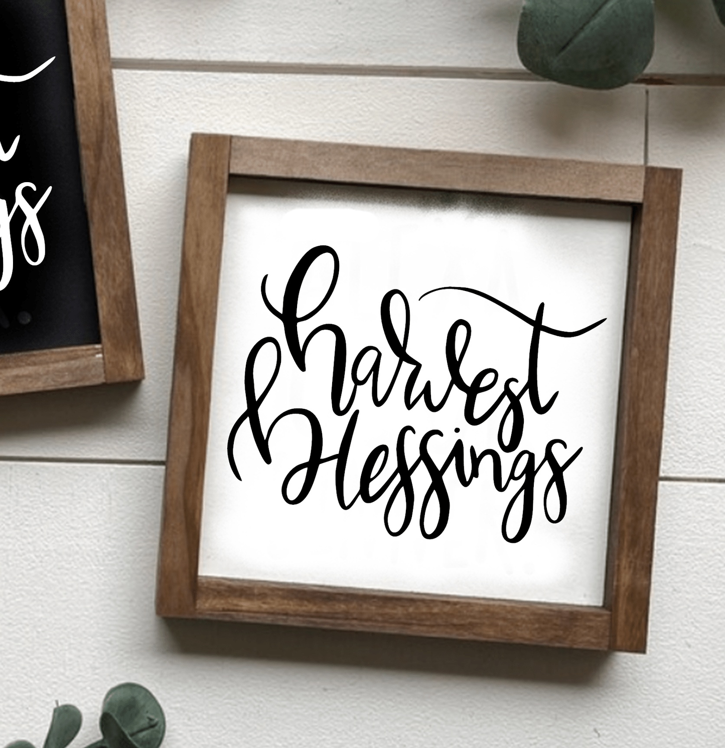 Hand-painted "Harvest Blessings" framed wood sign with white background and black lettering.