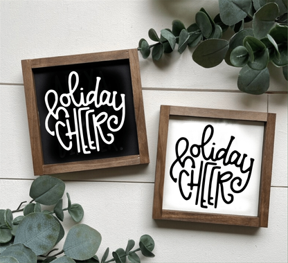 Handcrafted wood "Holiday Cheer" Christmas signs in rustic frames, available in black or white backgrounds, perfect for holiday decor.