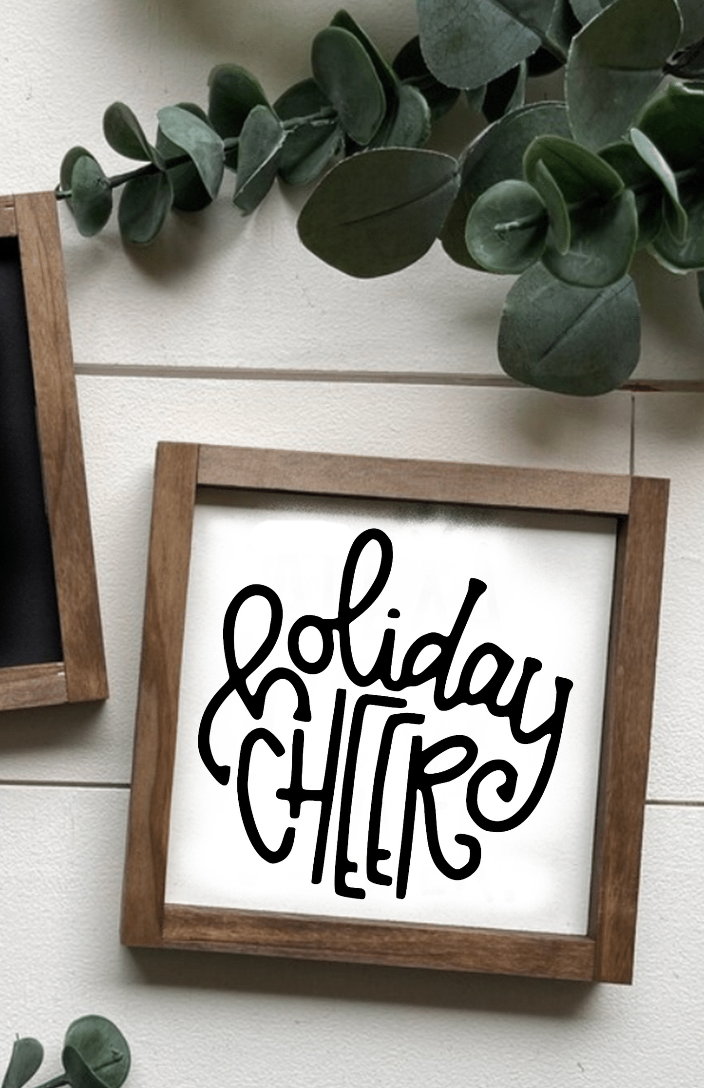 Handcrafted holiday cheer Christmas wood sign with black lettering on white background and rustic wooden frame.