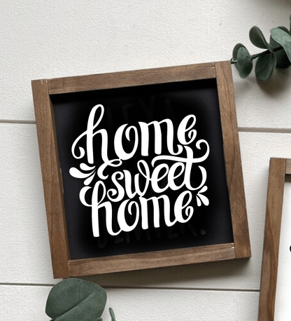 Handcrafted "Home Sweet Home" framed wood sign with black background and white lettering.