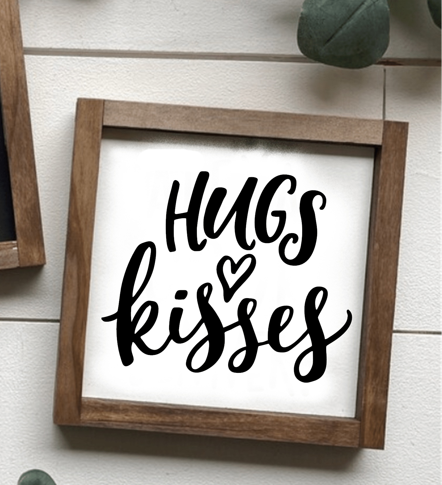 Hugs and Kisses handcrafted wood sign with stained frame and black lettering on white background.