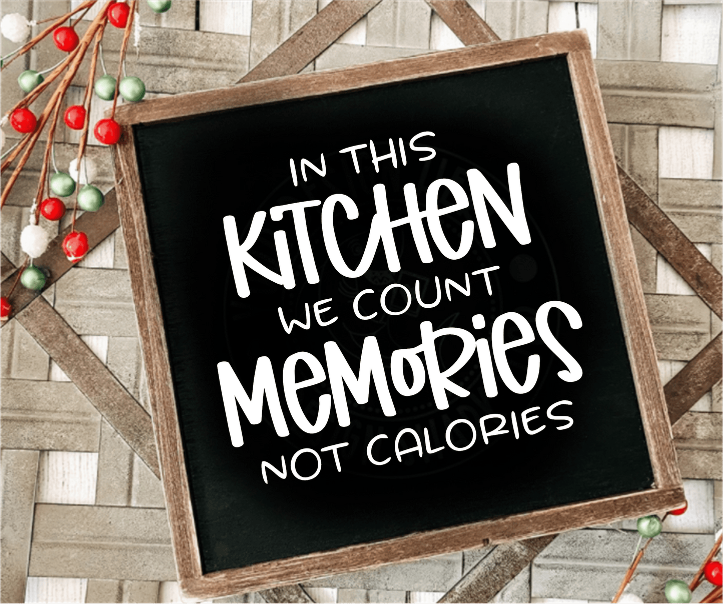 Framed wood sign with "In this Kitchen we Count Memories not Calories" on a black background.