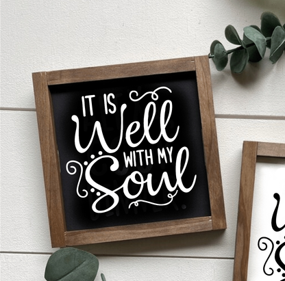 Handcrafted wood sign with "It is Well with my Soul" text, black background, and white lettering, framed in wood.