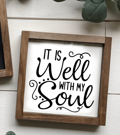 Handcrafted framed wood sign with "It is Well with my Soul" in black lettering on a white background, farmhouse decor.