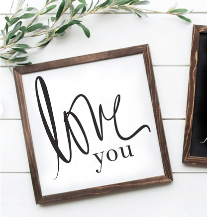 Handcrafted "Love You" framed wood sign with black lettering on a white background.