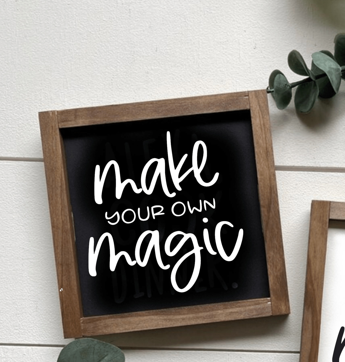 "Make Your Own Magic" framed wood sign with black background and white lettering, featuring natural wood frame.