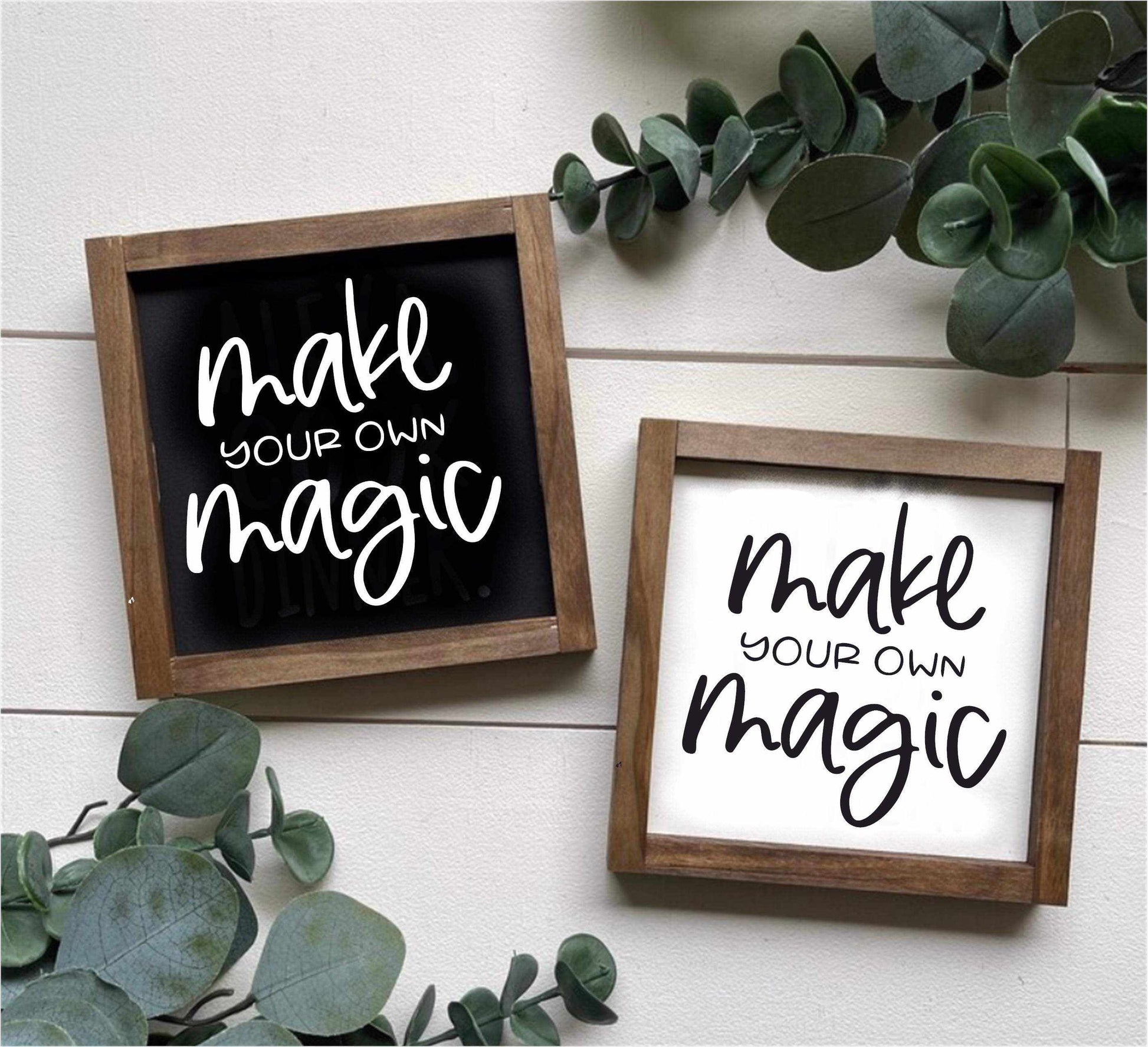 "Make Your Own Magic" framed wood sign in black and white backgrounds with greenery decor.