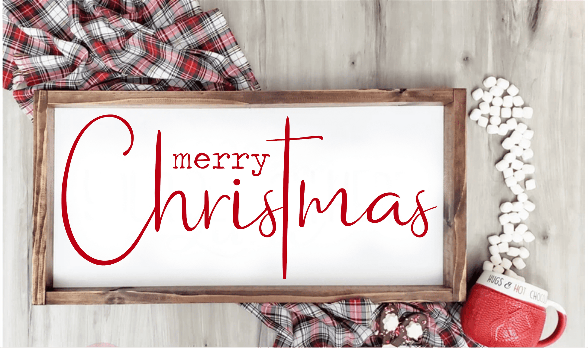 Handmade cross wood sign with "Merry Christmas" script in red on white background, surrounded by cozy holiday decor.