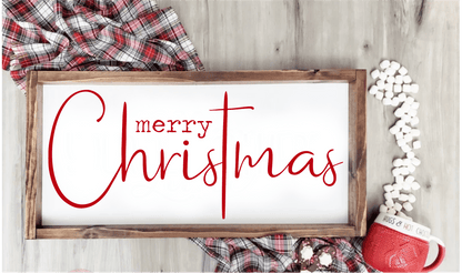 Handmade cross wood sign with "Merry Christmas" script in red on white background, surrounded by cozy holiday decor.