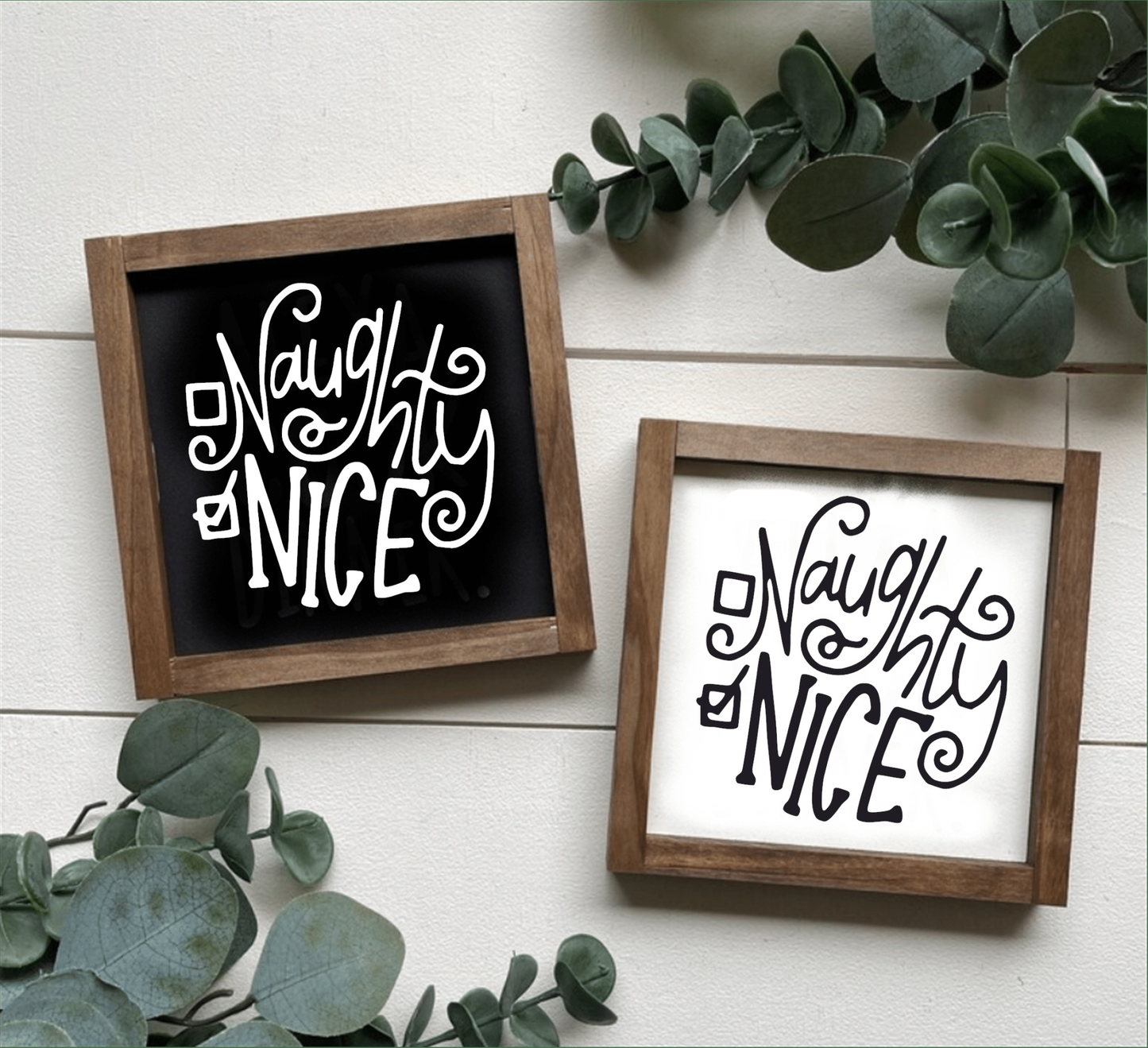 Handmade "Naughty or Nice" holiday wood sign with black and white lettering, framed with stained wood.