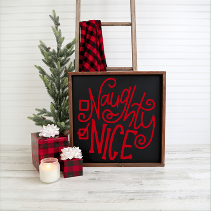 Handmade Naughty or Nice holiday wood sign with red lettering on black background, festive decor.