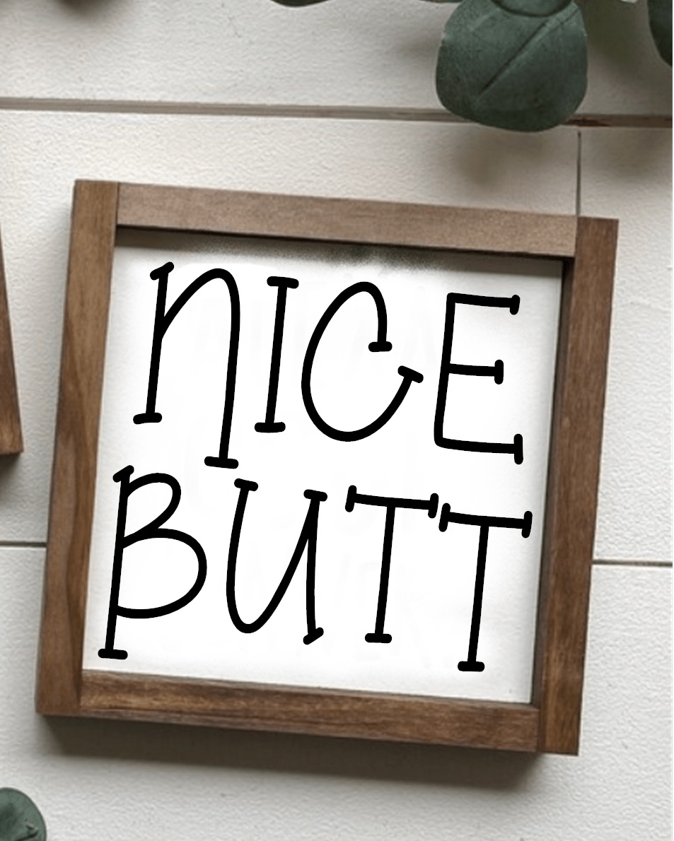 Handcrafted "Nice Butt" wood sign with stained frame, white background, and black lettering. Perfect for bathroom decor.