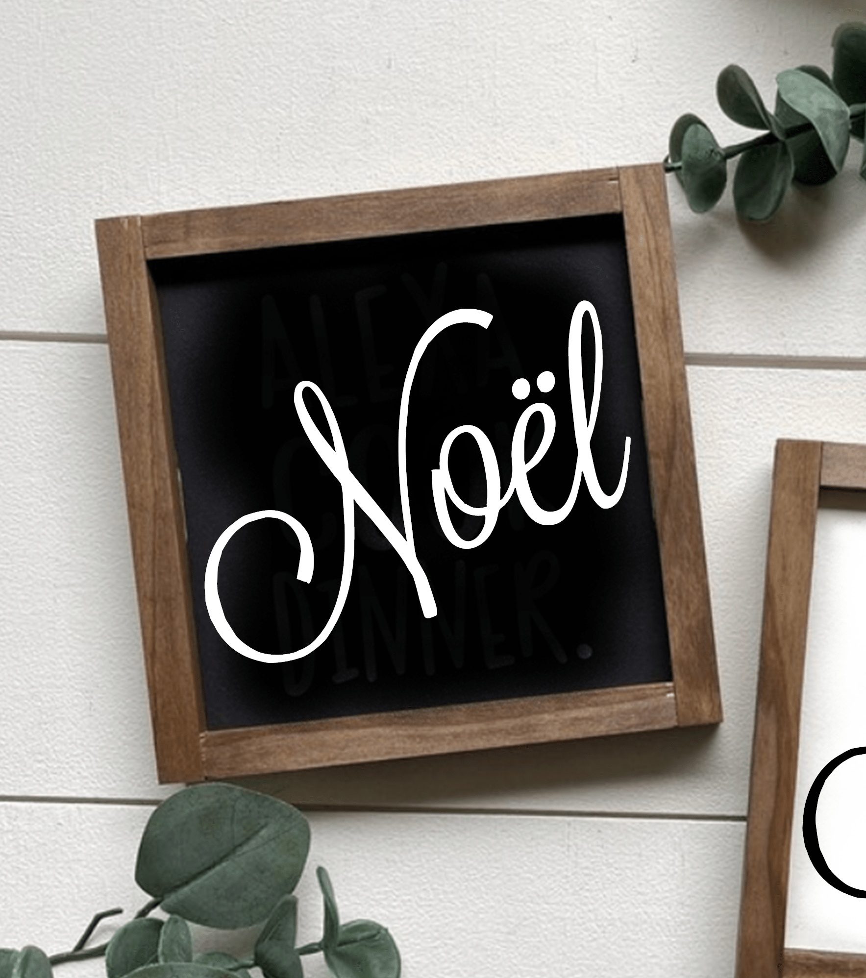 Handcrafted "Noel" framed wood sign with black background and white lettering.