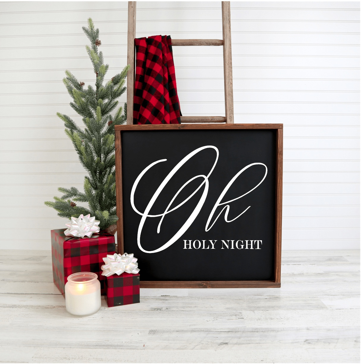 Oh Holy Night handmade Christmas wood sign with black background and white lettering displayed with festive decor.