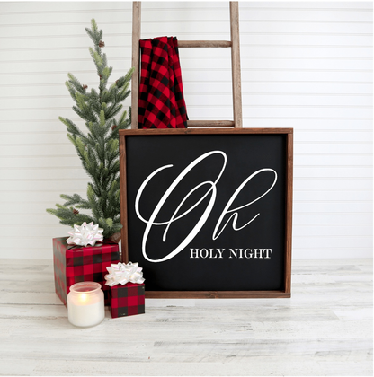 Oh Holy Night handmade Christmas wood sign with black background and white lettering displayed with festive decor.