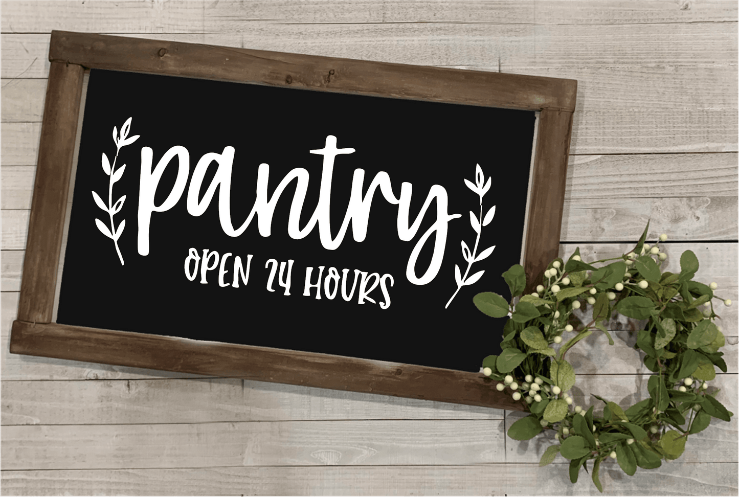 Wood framed pantry sign with "Pantry Open 24 Hours" in white lettering on a black background, farmhouse style decor.