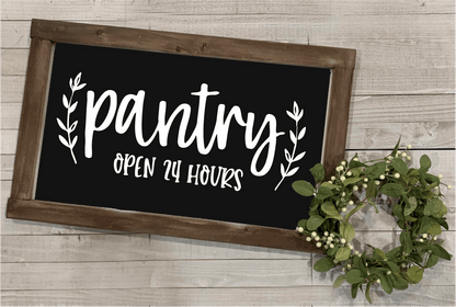 Wood framed pantry sign with "Pantry Open 24 Hours" in white lettering on a black background, farmhouse style decor.