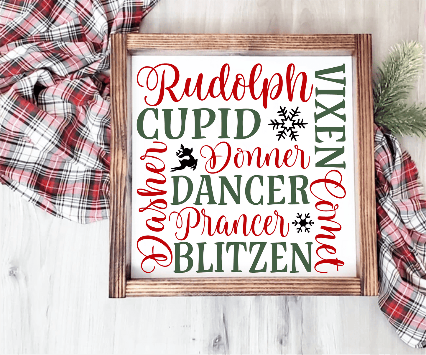Handmade wood Christmas sign with reindeer names in red and green on a white background, framed in stained wood.