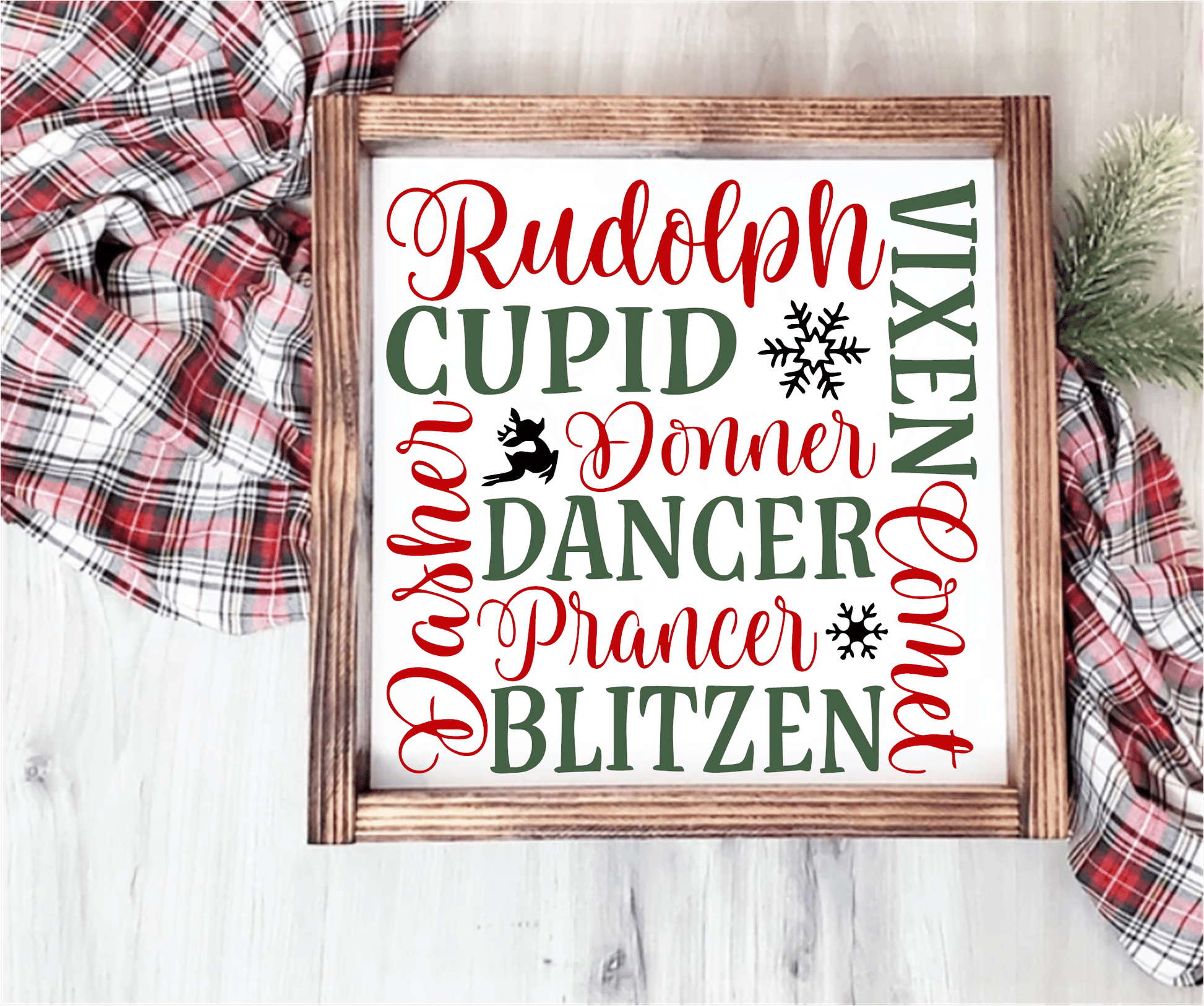 Handmade wood Christmas sign with reindeer names in red and green on a white background, framed in stained wood.