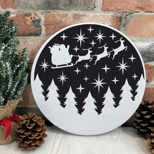Handmade Santa and Sleigh wood sign with reindeer and trees, 12-inch round pine decor.