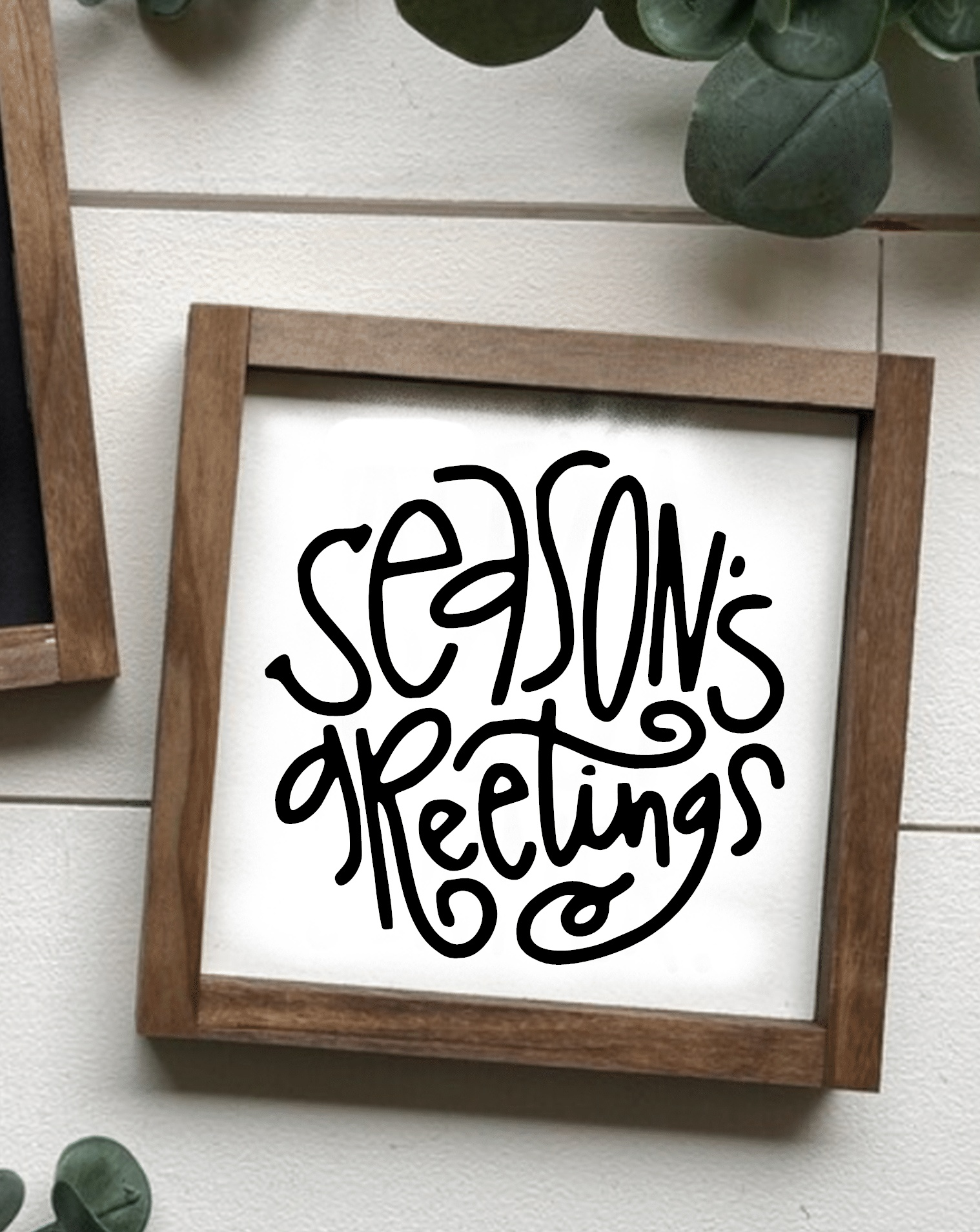 Handcrafted "Season's Greetings" holiday wood sign with black lettering on white background.
