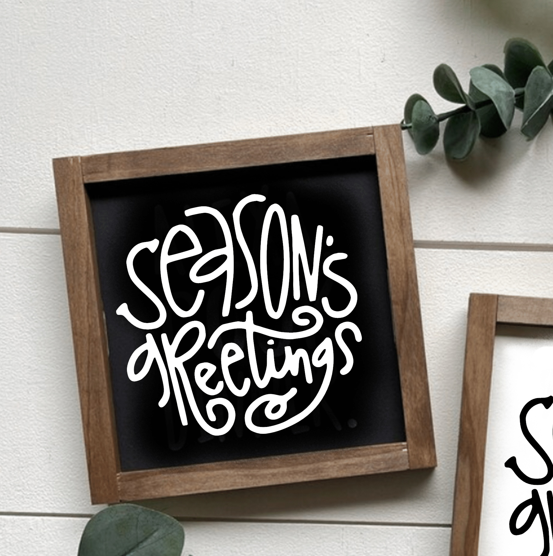 Season's Greetings holiday wood sign with handcrafted design, black background, and white lettering.
