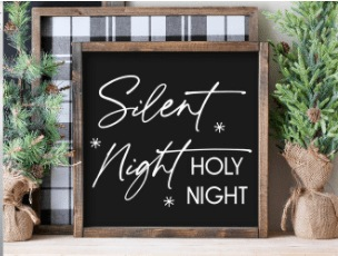 Handmade "Silent Night, Holy Night" wood sign with black background and white lettering, framed in stained pine.