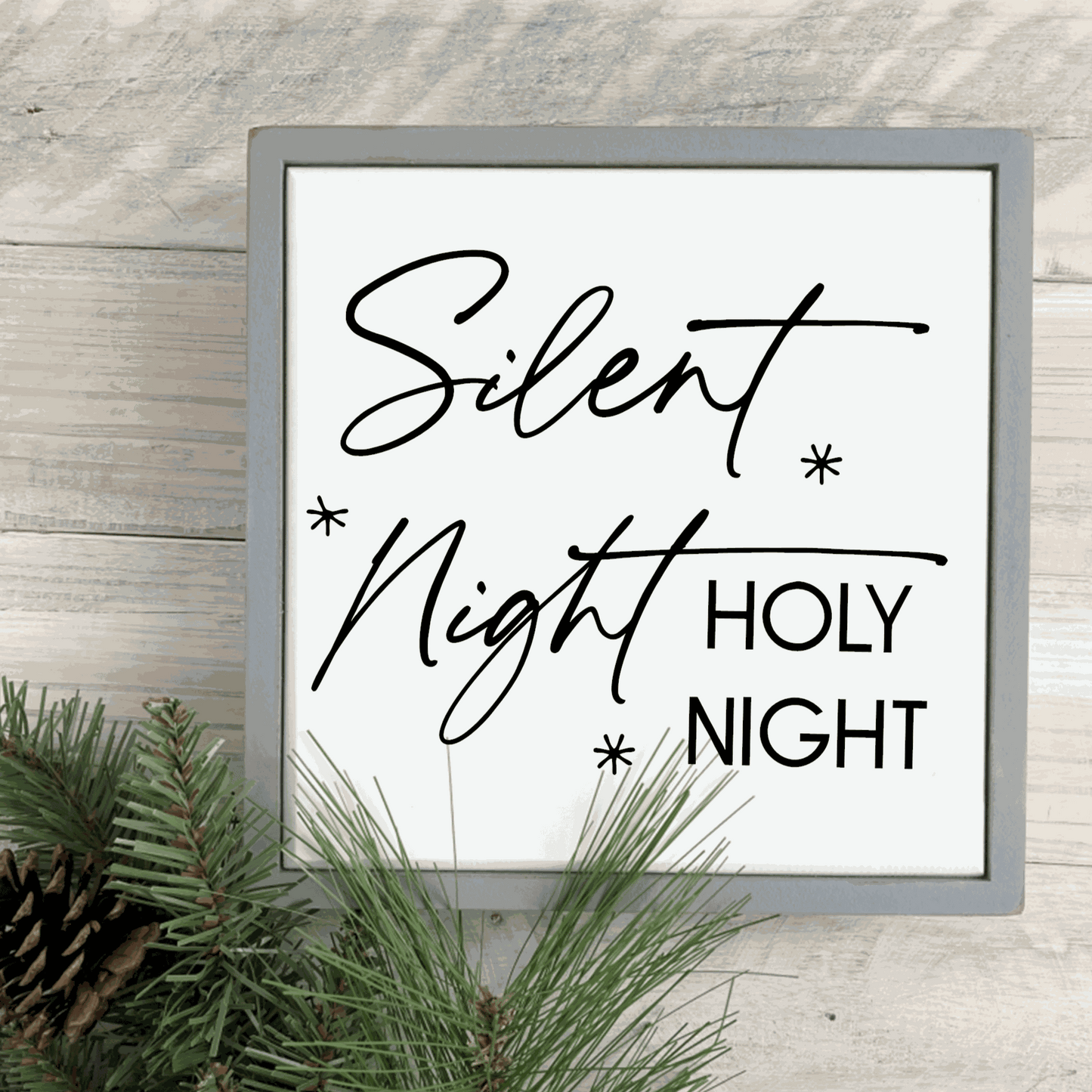 Handmade "Silent Night, Holy Night" wood sign with black lettering on white background, framed with stained pine.