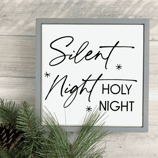 Handmade "Silent Night, Holy Night" wood sign with black lettering on white background, framed with stained pine.