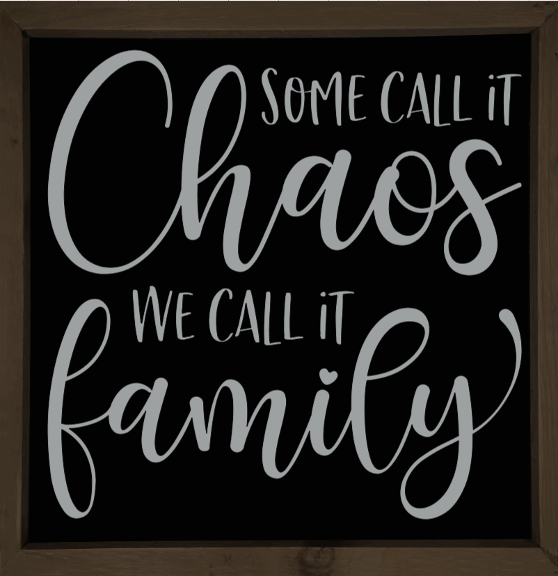 Handmade wooden sign with "Some Call it Chaos, We Call it Family" text on black background.