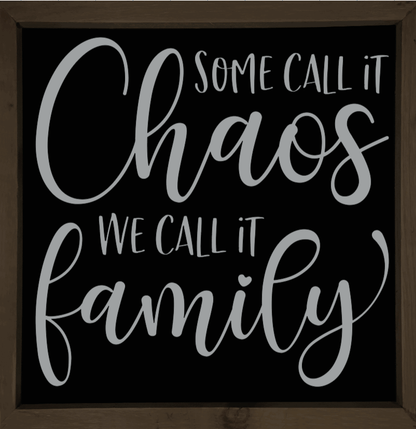 Handmade wooden sign with "Some Call it Chaos, We Call it Family" text on black background.