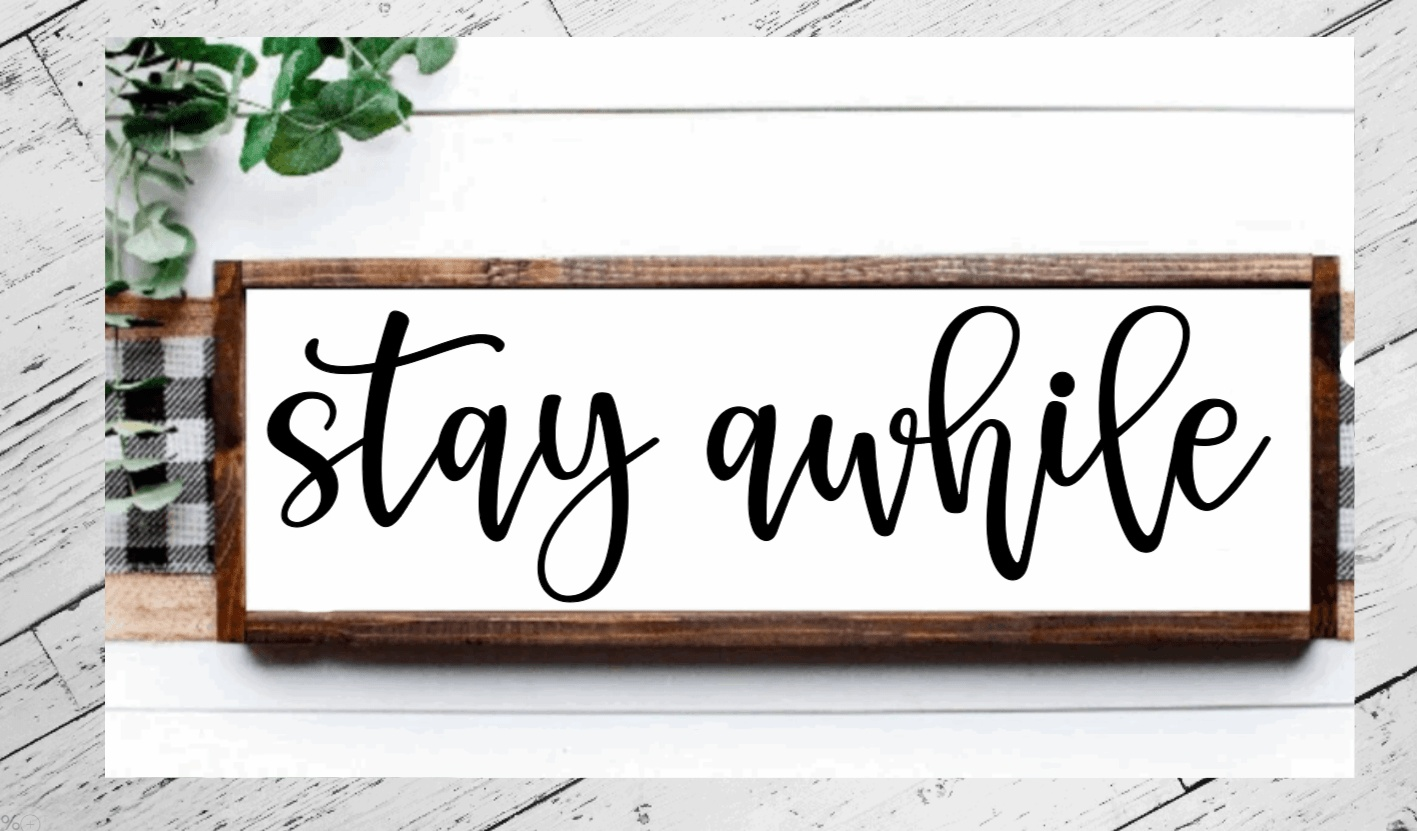 Handmade "Stay Awhile" rustic wood sign with black script on a white background, wooden frame.