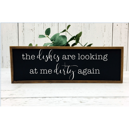 Rustic kitchen sign with humorous quote, white background, black lettering, wood frame.