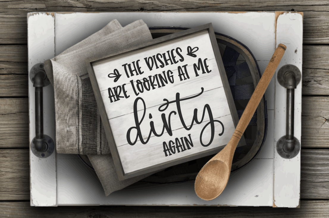 Rustic kitchen sign with "The Dishes are looking at me Dirty Again" text on white wood background, ideal for gifts.