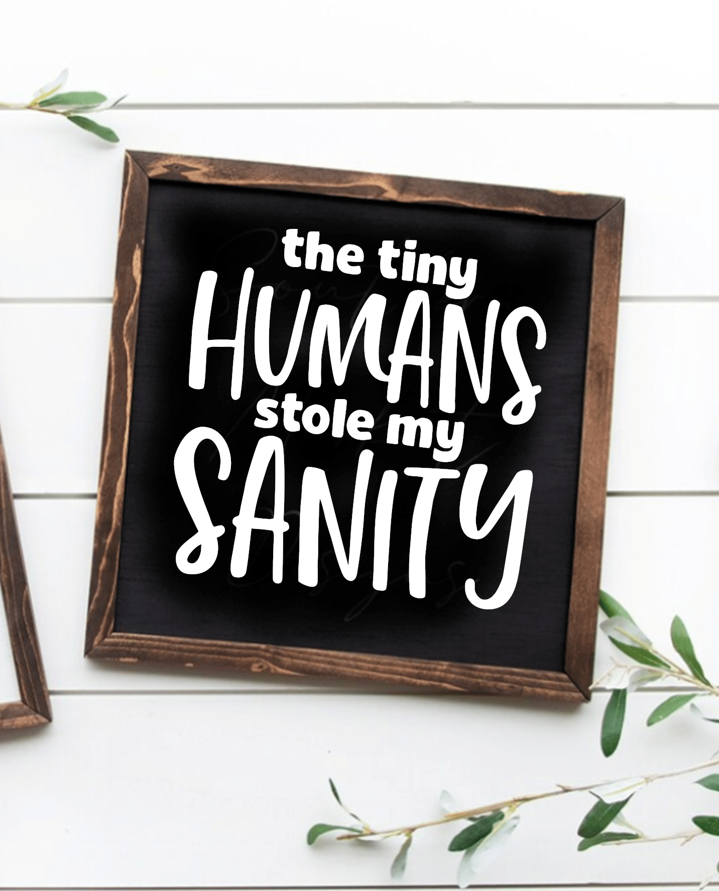Wood sign with the phrase "The Tiny Humans Stole my Sanity" in white lettering on a black background, framed with a rustic wood finish.